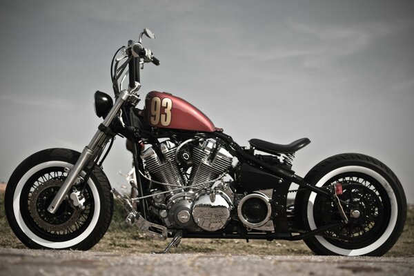 A beautiful motorcycle with a number on the tank