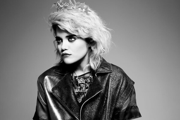 Monochrome portrait of a young blonde in a fashionable leather jacket