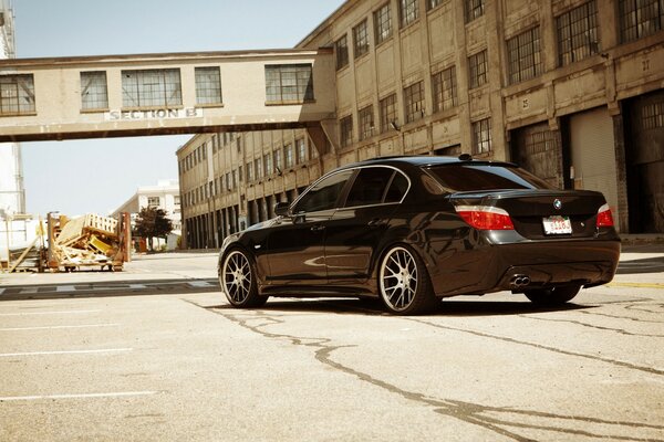 Black car on the background of an industrial building