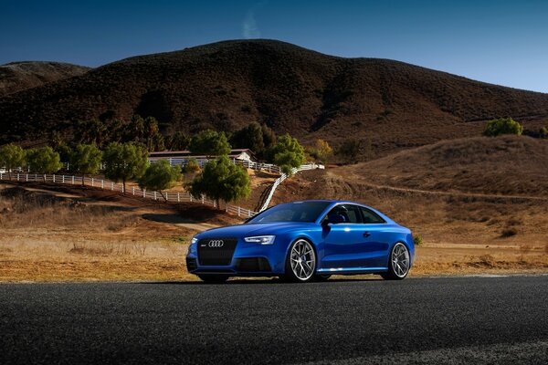 Blue audi on a deserted road