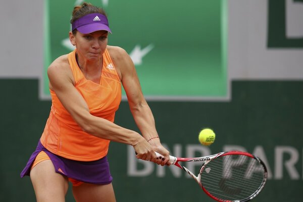 Tennis player hits the ball with a racket