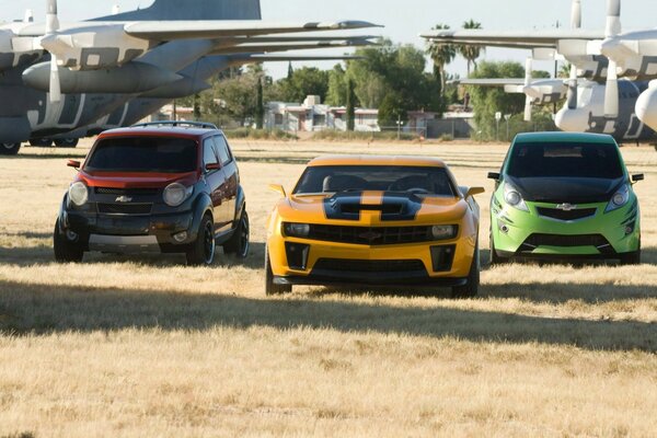 Cars and planes on the same field