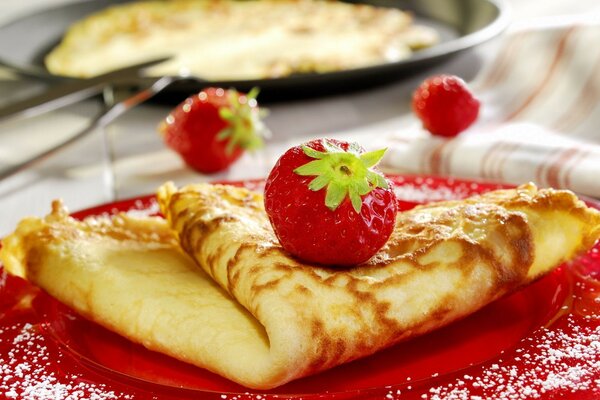 Homemade pancakes sprinkled with strawberries