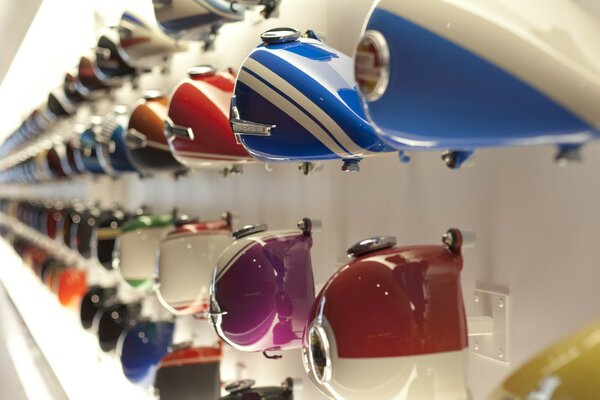 Colored motorcycle gas tanks on the rack