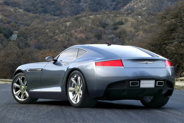 Silver Bentley on the road in the mountains