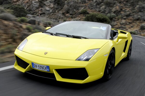 The bright lambargini is in a hurry on the perfect road