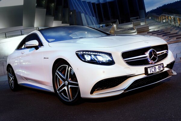 Beautiful white car in the middle of the night city