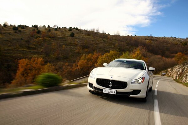 Maserati white on a beautiful road