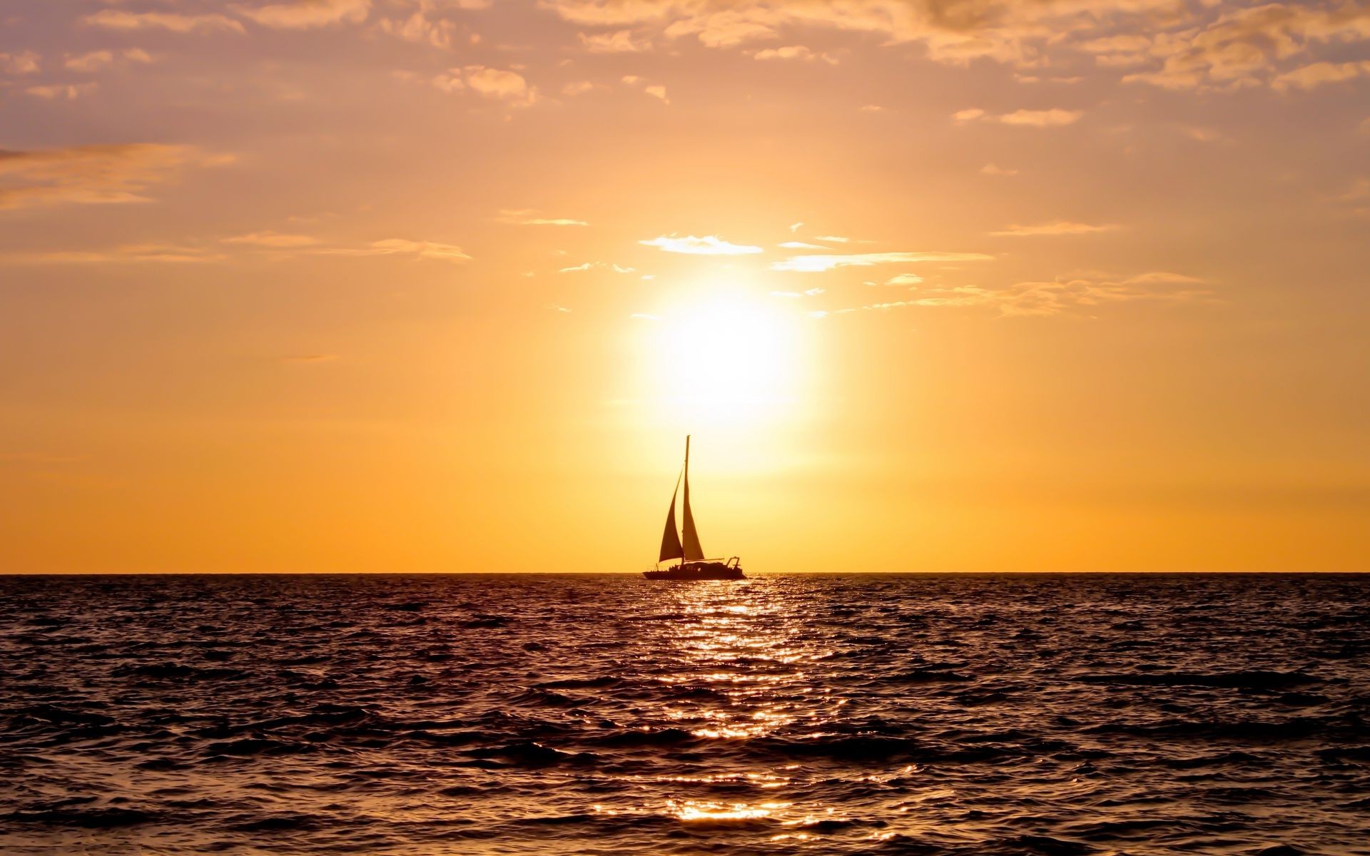 the sunset and sunrise sunset water sea dawn ocean sun boat dusk sailboat evening seascape beach watercraft sky reflection ship light summer