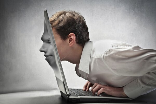 An office worker plunges into work with his head