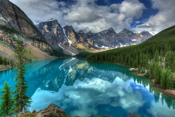 Mountains and sky are reflected in the water