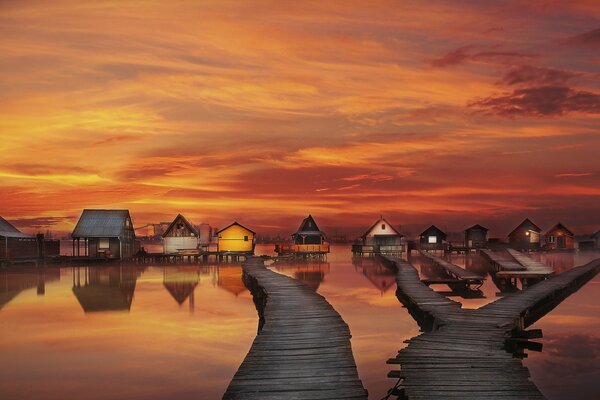 Houses on the background of the reflection of the sunset sky