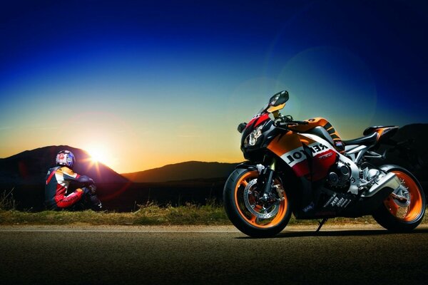 A sport bike and a rider next to it