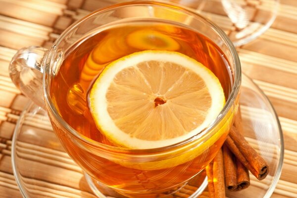 Beautiful image of tea with lemon and cinnamon sticks