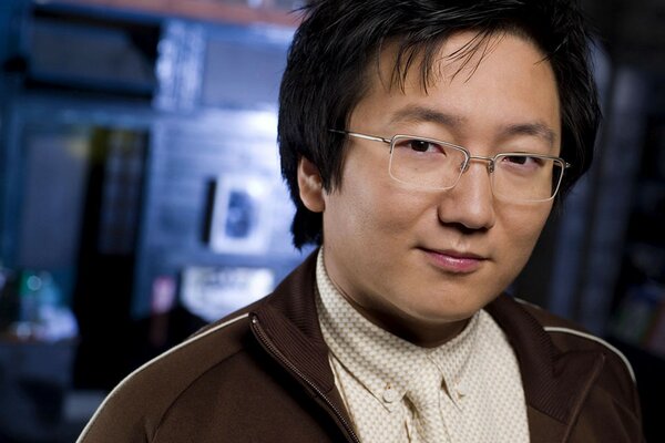 A man with glasses on a blurry background