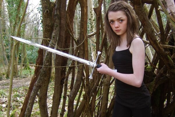 Girl outdoors with a sword from the TV series