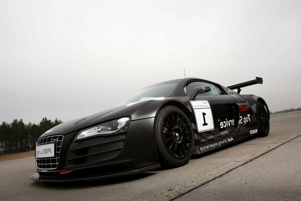 Black car on wet asphalt