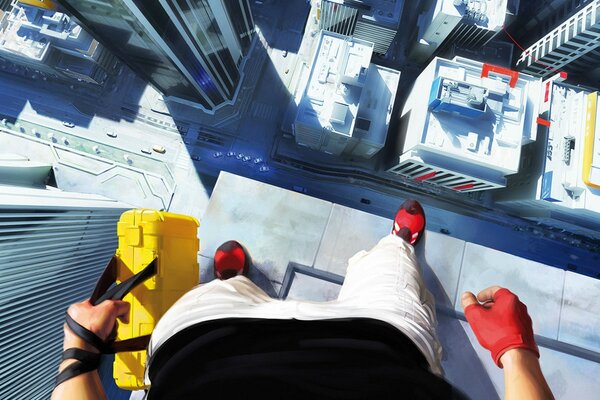 A man on the edge of a skyscraper with a briefcase in his hands