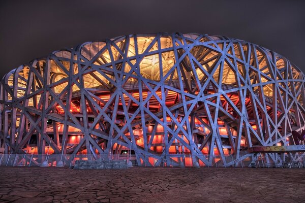 Swallow s Nest Stadium in Beijing at night with lighting