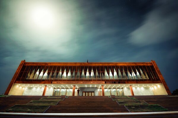 An architectural example of a house against a dark , night sky