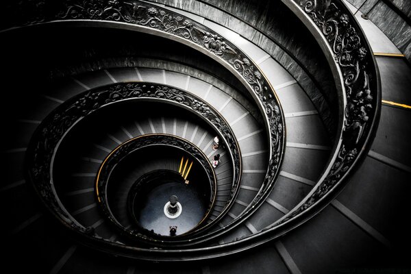 Spiral staircase with patterned railings in gray and black tones