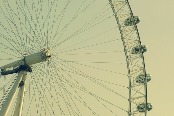 A huge Ferris wheel on the background of a suitable sunset