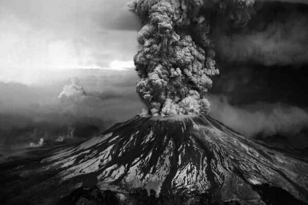 Eruption of a volcano with a high column of smoke