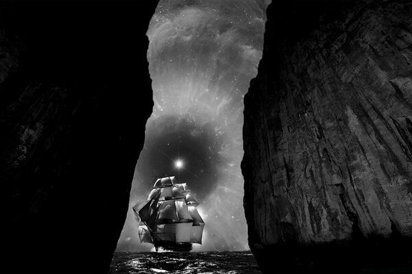 Sailboat in the night by the caves