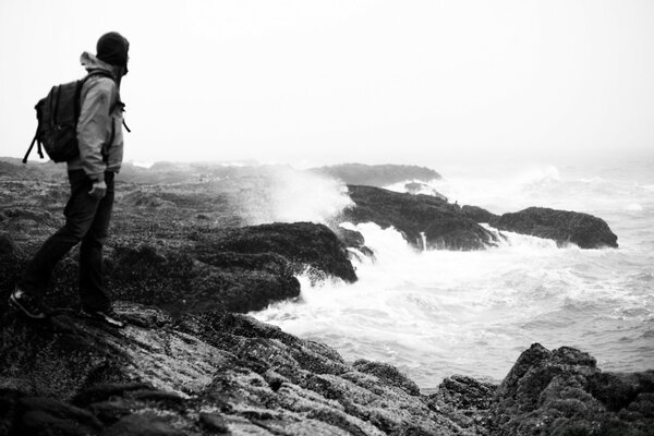 Black and white photo of a traveler on the shore