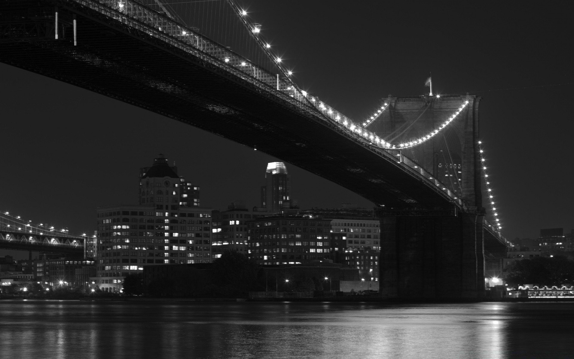 black and white bridge city river architecture water suspension bridge evening travel building light urban connection dusk reflection cityscape transportation system construction sky skyline landmark