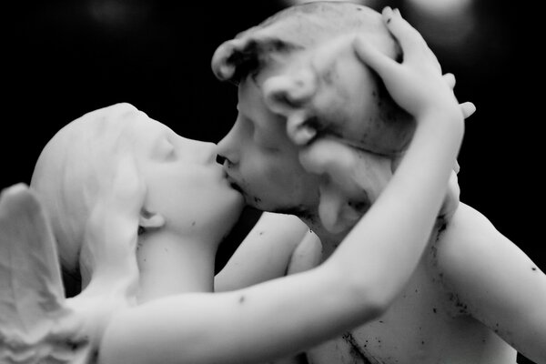 A kiss. Monochrome image of a sculpture fragment