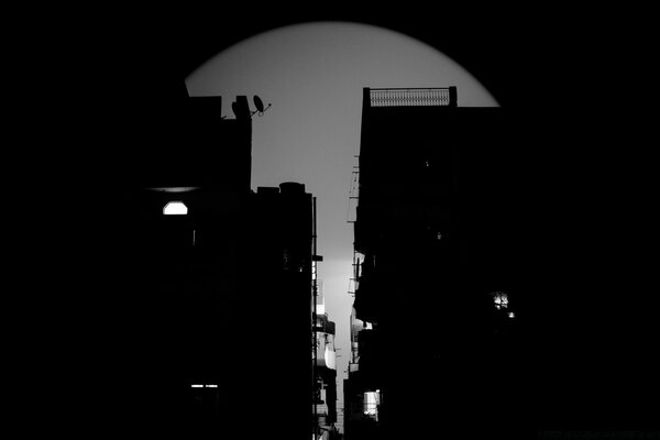 Silhouette of a narrow street in the light of the moon