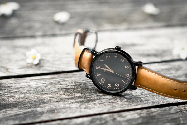 Clock on a bench with flowers