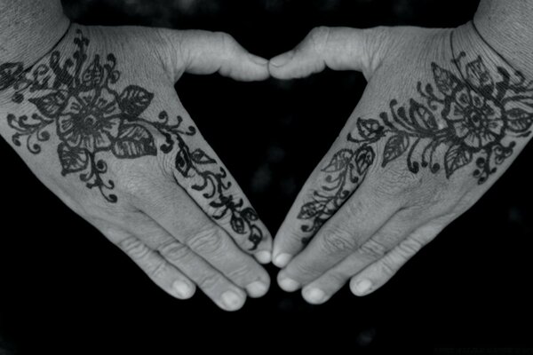 Hands of a woman with stuffed tattoos symbolism black and white photo