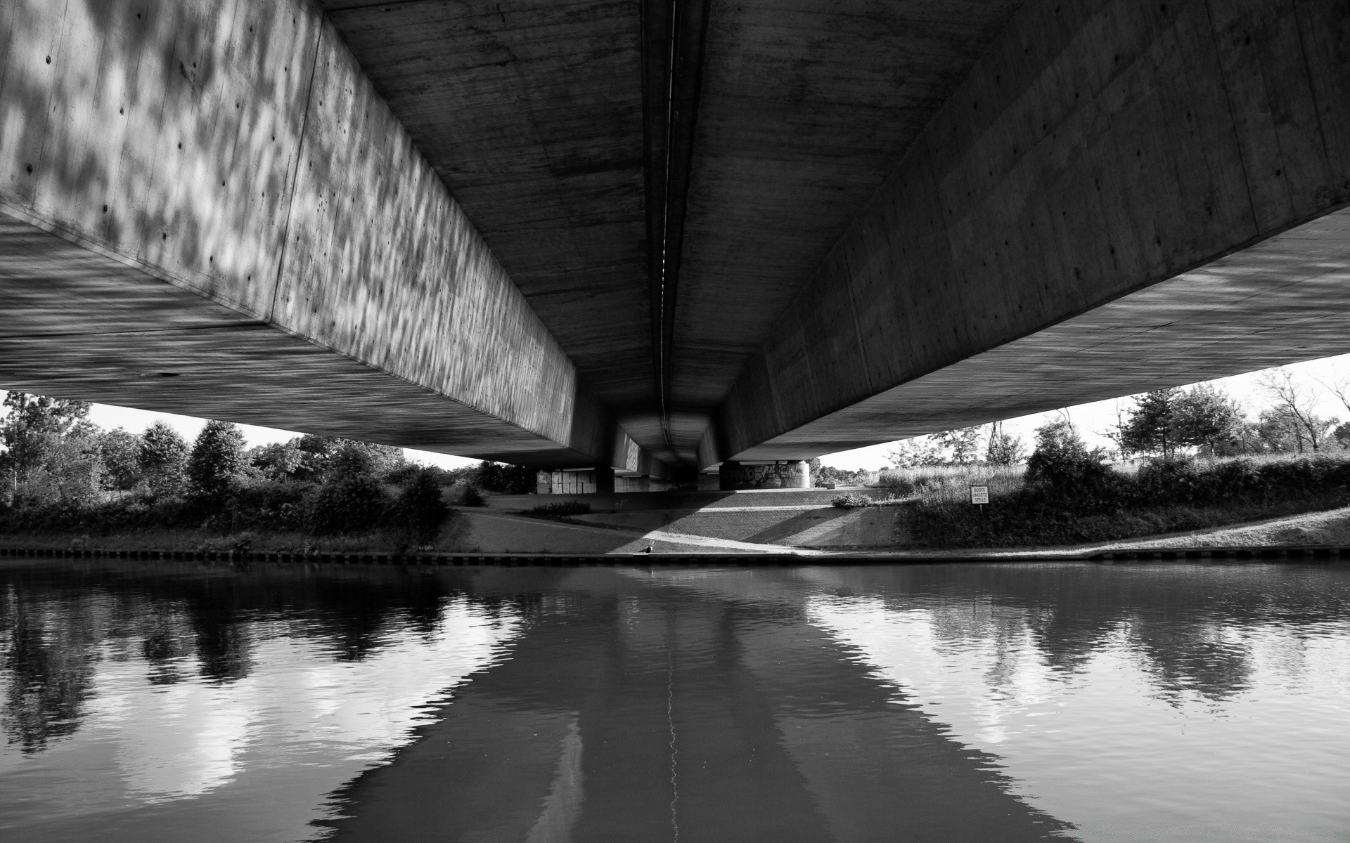 black and white monochrome bridge reflection water architecture river transportation system light city urban dark travel building sky street construction