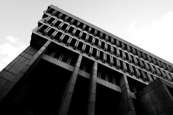 Black and white photo of a building against the sky