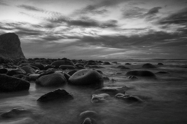 Stones in the sea against the sky