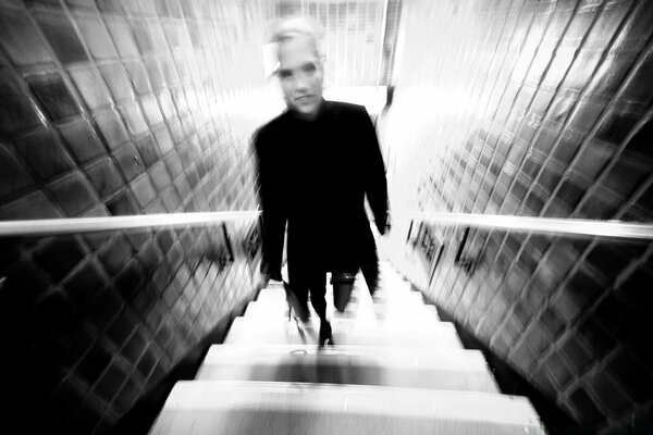 Man climbs stairs blurry black and white