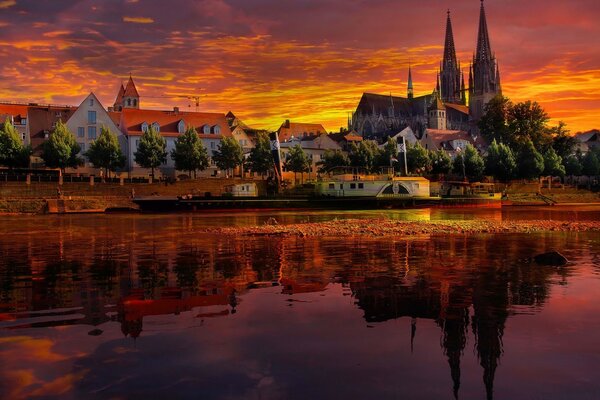 Buildings by the lake at red sunset