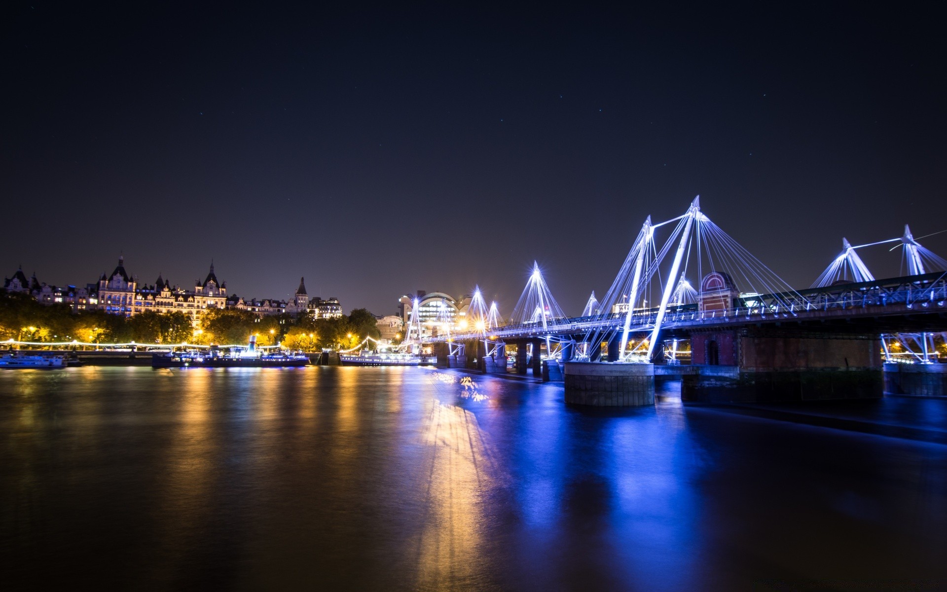 other city bridge water travel river dusk evening city sunset sky architecture reflection transportation system traffic waterfront downtown light cityscape urban illuminated