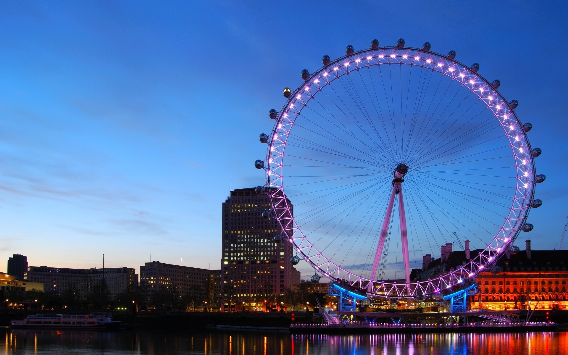 other city ferris wheel sky architecture travel city bridge water river festival outdoors entertainment dusk urban building light evening fun