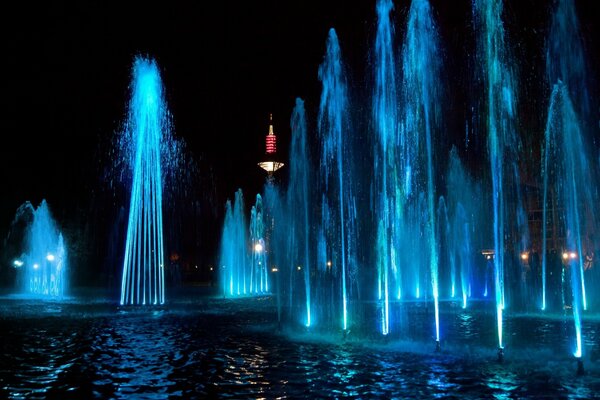 Photo of a colored fountain at night