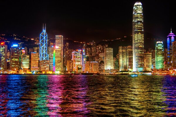 Sparkling skyscrapers are reflected in the water