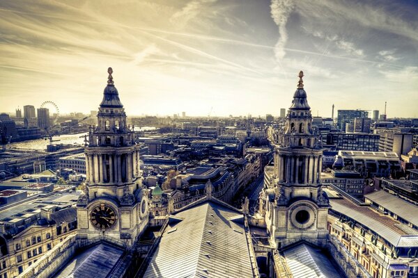 Clock towers high above the city in cloudy weather