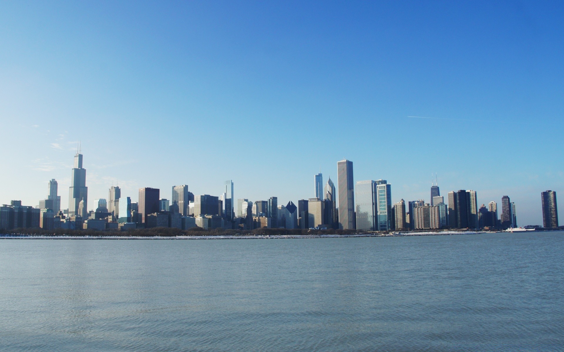 other city skyline skyscraper downtown city architecture cityscape water office building sky travel business waterfront harbor sunset river