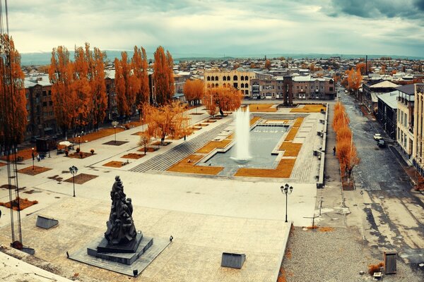 The fountain was surrounded by autumn trees