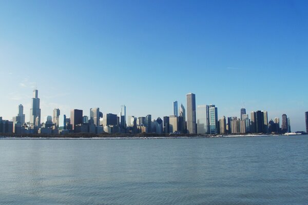 The blue sea and skyscrapers can be seen in the distance