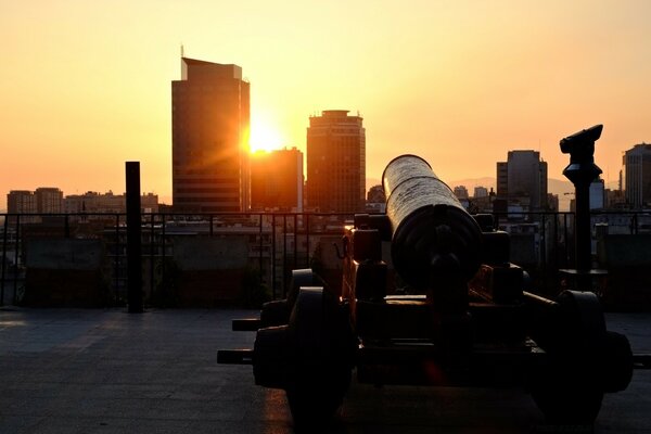 Urban landscape with high-rise buildings on the background of sunset