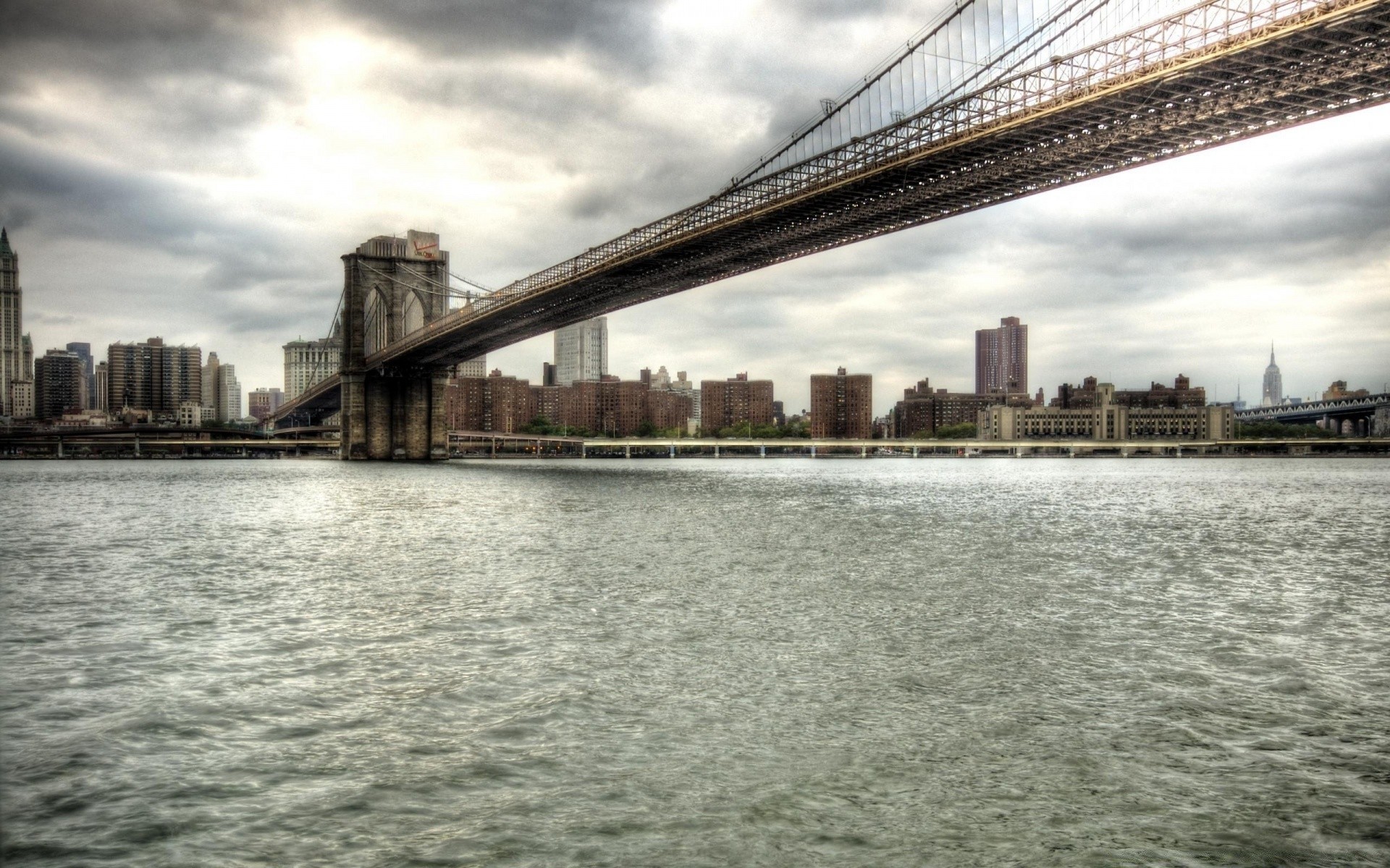 other city bridge city architecture river water cityscape skyline urban building travel landmark sky reflection construction modern suspension bridge skyscraper tower downtown transportation system