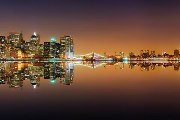 The lights of a big city on the background of a calm river